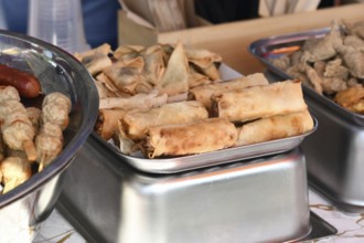 Tray of fried Asian springrolls and wontons at street food market