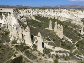 High rock towers rise in an impressive valley scenery in Cappadocia, aerial view, Love Valley,