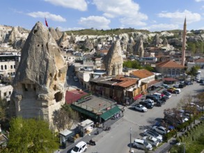 View of a town in Cappadocia with characteristic rocks and traditional architecture under a blue