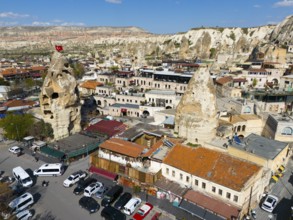 Historical buildings in combination with impressive rock formations with an urban backdrop, aerial