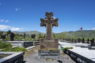Detailed stone cross monument in a peaceful landscape at a cemetery, Gyumri, Alexandropol,