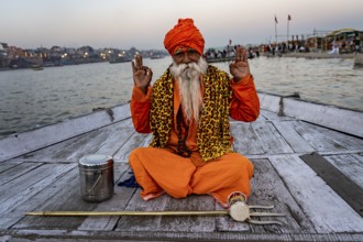 Sadhu with trident on boat, Katesar, Mughalsarai, Uttar Pradesh, India