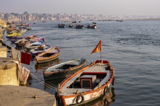 River Ganges with boats and Varanasi in the background, Shivala, Varanasi, Uttar Pradesh, India