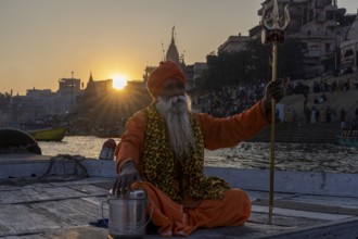 Sadhu with trident on boat, Mughalsarai, Uttar Pradesh, India