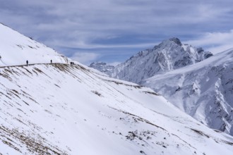 People walking through the snow, in the high mountains, Himalayas, Spitital, Kaza, Himachal