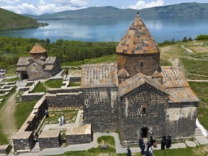 Stone monastery church with picturesque view of the lake and the mountains in the background,