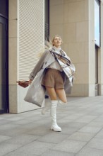 A model captures attention on a bustling city sidewalk, showcasing a trendy ensemble featuring a