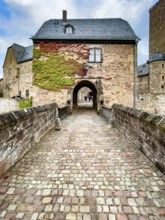 Front access with historic bridge over moat Hirschgraben to gatehouse of Steinau Castle, Steinau an