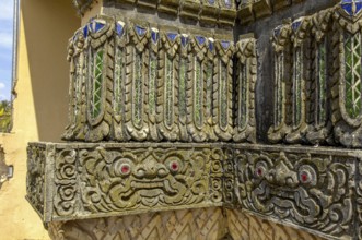 Relief work bas-relief by stonemason on outer wall of Buddhist monastery, Koh Lanta, Thailand
