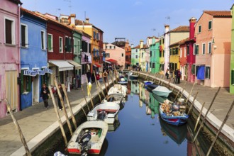 Strollers along the canal, typical street scene in winter, boats, colourful facades, various