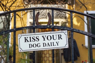 Funny sign on the iron gate, warning about the dog, facade detail, Burano, Venice, Italy