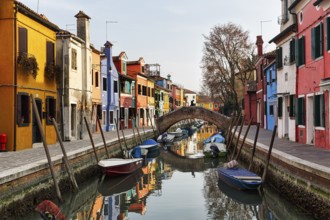 Pedestrian bridge, arched bridge over canal, typical street scene in winter, colourful facades in
