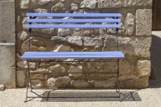 Blue bench in front of a house facade, Provence, France
