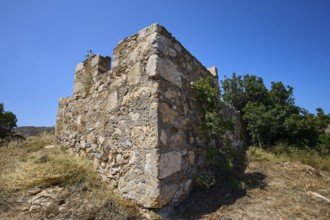 Old stone ruins with surrounding vegetation under a clear blue sky, Panagia tou Paleokastro, Church