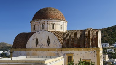 Historic domed church with weathered dome under a blue sky in a Mediterranean setting, Panagia tou