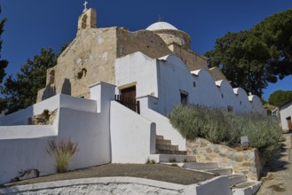 Side view of a whitewashed stone church with surrounding trees, Basilica, Church, Agios Theologos,