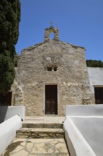 Symmetrical view of a stone church entrance with steeple, Basilica, Church, Agios Theologos, Leros,