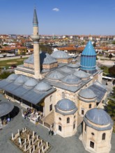 Detailed mosque with decorated dome and minaret in the background of the city view, aerial view,