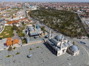 Mosque and surrounding green spaces next to an extensive urban landscape, aerial view, Mevlânâ