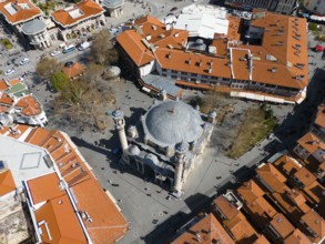 Centrally located mosque with red roofs, lively cityscape from a bird's eye view, aerial view,