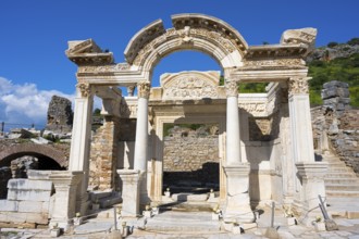 Ancient ruins with an ornate arch and columns against a blue sky, Hadrian's Temple, Efes, Ephesus,