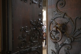 Solid wooden door with ornate iron fittings and door knocker, St Mary Abbot Church, Kensington,