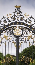 Magnificently decorated iron gate with golden ornaments and crown, Kensington, London, England,