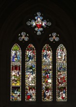 Stained glass window with religious depictions and bright colours, St. Mary Abbot Church,