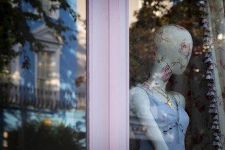 Mannequin in floral pattern, reflection in shop window, Portobello Road, Notting Hill, London,