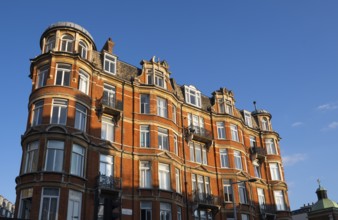 Large red brick building with bay windows and balconies, Notting Hill, London, England, United