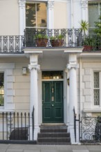 Classicist house façade with columns and green door, Kensington, London, England, Great Britain