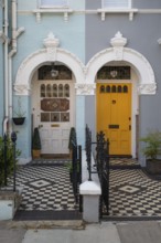Victorian house entrances with coloured doors and decorative tiles, Kensington, London, England,