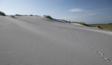 Sandy dune landscape, footprints, holidaymakers, blue sky, Hvide Sande, North Sea, Denmark