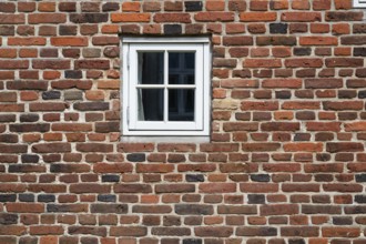 Close-up of a brick wall with a small white window, Old Town, Ringkøbing, Ringkøbing Fjord, Denmark