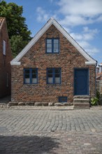 A traditional brick house with a blue door and blue windows, Old Town, Ringkøbing, Ringkøbing