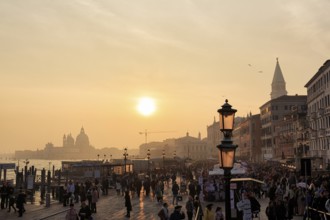 Crowd, Boat dock at St Mark's Square, St Mark's Basilica, Church on the horizon, Sunset in winter,