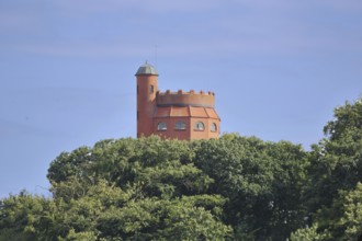 Red water tower with battlements built in 1913, looking out of the forest, spire, Mölln,