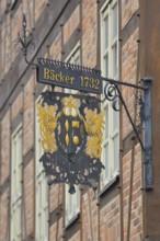 Nose plate with golden date 1732 on the brick house, half-timbered house, window, wrought-iron