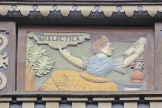 Allegorical woodcarving with figure on dialectics, philosophy, rhetoric talk, conversation, scroll,