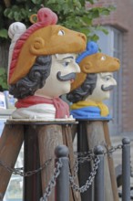 Colourful Swedish heads as landmarks, historical wooden head with face and four eyes, Swedish head