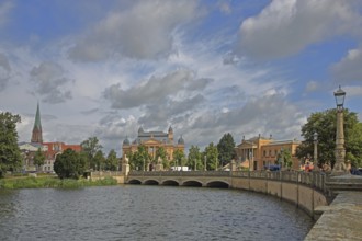 View over the castle lake to the castle bridge with tower of the cathedral, state theatre and state