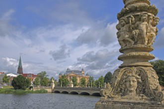 View over castle lake to the castle bridge with relief, detail, putti, face, children, figures,