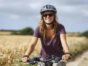 A young woman with a bicycle helmet rides a bicycle and smiles friendly into the camera, AI