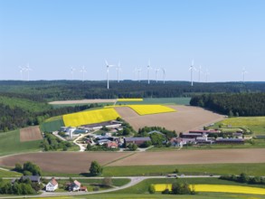A landscape with wind turbines and yellow fields under a clear sky, near Böhmenkirch, Swabian Alb,