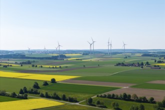Flat landscape with wind turbines and yellow fields under a clear sky, near Böhmenkirch, Swabian