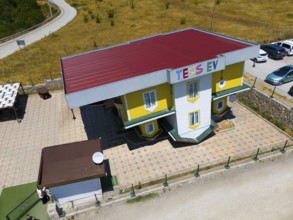 Building with car park against a rural backdrop, aerial view, Ters Ev, upside down house,