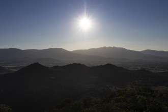 The sun rises over the mountainous landscape of Sardinia, Monte Nai, Costa Rei, Sardinia, Italy