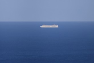 A cruise ship passes near the Costa Rei on the Mediterranean Sea near Sardinia, Monte Nai, Costa