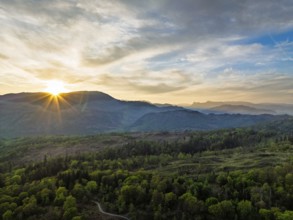 Sunset over Mountains and Coniston Water from drone, Lake District National Park, Cumbria, England,