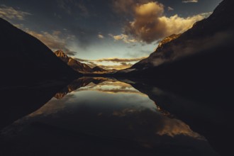 Sunrise with reflections in Lake Heiterwanger See in Tyrol in the Alps in Austria